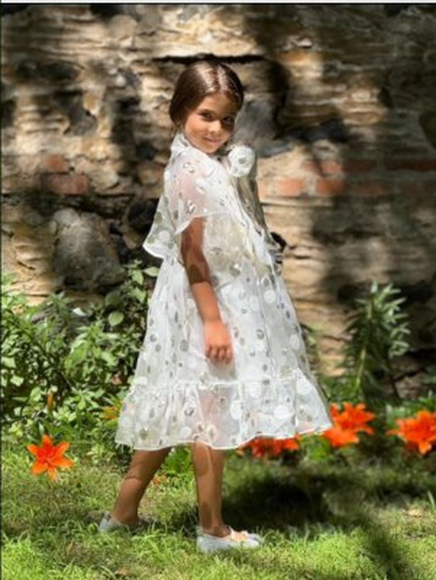Girl in an embroidered dress in a garden
